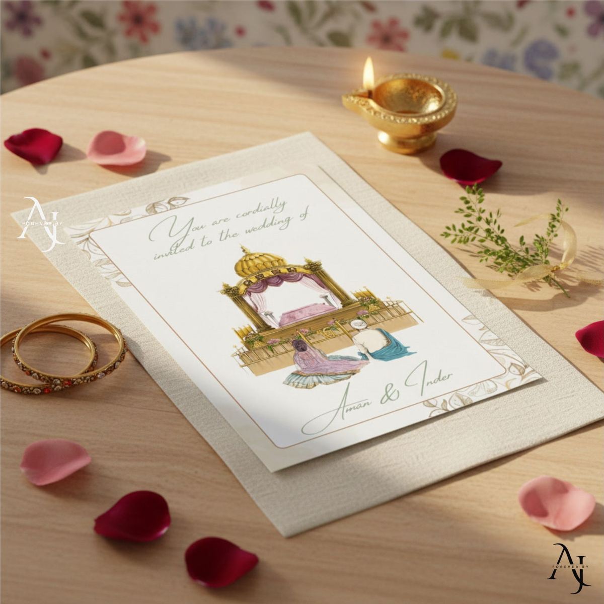 White and gold Sikh wedding invitation on a table with a lit diya, gold bangles and rose petals